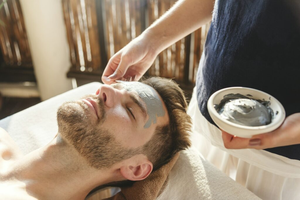 Man getting a mud mask at a spa